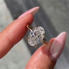 a close up of a person holding a ring with a diamond in it's center