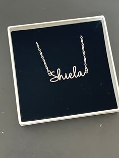 This necklace features a Dainty Sterling Silver Personalized Name Necklace with Chain. You can have your own name or word made. All carving will be made in the font as the photo.  This name necklace and chain are dainty. DIMENSIONS Width - 2.3cm  Height - 0.3cm Total Weight - 3 gram Chain Size - 1.2mm This Jewellery comes in a box ready for gifting.  Please select necklace length from the drop-down box during check out. You may choose to buy Name+Chain or just our Chain without the name in the o Customizable Silver Chain Necklace For Gift, Customizable Silver Signature Necklace, Customized Letter Necklaces, Silver Custom Name Signature Necklace, Silver Signature Custom Name Necklace, Signature Silver Custom Name Necklace, Silver Signature Necklace With Name, Signature Silver Necklace With Name, Silver Signature Necklace With Custom Name