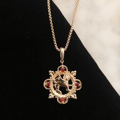 This past summer we visited Musee Cluny in Paris as part of our middle ages research and happened upon a gorgeous griffon from 1000AD. We Recreated it as a necklace and added some ruby red stones for added regal flair. Team Gryffindor? Brass plated in 18K gold with ruby red cubic zirconia stones. 16" chain with 3" extension for additional length. All orders over $50 ship for free within the USA. All orders usually ship within 24 hours from the USA. Red Victorian Medallion Jewelry, Victorian Red Medallion Jewelry, Red Ruby Victorian Necklace, Gryffindor Jewelry, Gryffindor Necklace, Slytherin Necklace, Ahs Style, Gryffindor Aesthetic, Yule Ball