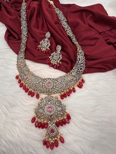 AD Red Stone Red Beads Dual Polish Long Necklace with screw back  earrings Victorian finish gives diamond look to the necklace. Fine quality and craftmanship. Premium quality. Ideal for desi weddings, House warmings baby showers. It has an adjustable cord(dore) back thread hence can adjust length. Necklace Length : 24 Inches Approx. Earring Length : 2 inches; Screw Back Ready to ship from Massachusetts, USA If you have any questions please let me know. Red Cubic Zirconia Jewelry Sets For Celebration, Red Cubic Zirconia Jewelry Sets, Ruby Jewelry Sets For Celebration, Red Bridal Festive Earrings, Festive Red Bridal Earrings For Formal Occasions, Ruby Jewelry Set With Stone Work As Gift, Traditional Red Diamond Earrings, Ruby Jeweled Necklaces For Wedding, Ruby Jewelry With Stones For Wedding