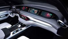 the interior of a modern car with touchscreens and steering wheel controls on display