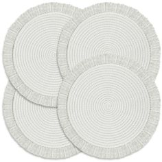 three white circular rugs on a white background