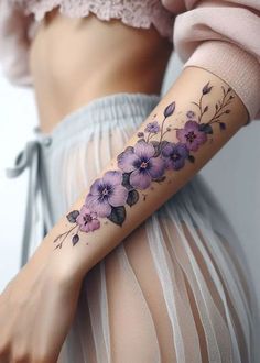 a woman's arm with purple flowers on it