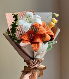 a person holding a bouquet of flowers in their hand