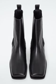 Defined by their angular shape, these modern Chelsea boots feature sharp square toes and Cuban heels. They're crafted from supple leather and designed with elasticated panels and pull tabs so you can put them on without creasing the hide. COS supports responsible manufacturing via the Leather Working Group  Upper & lining: 100% Leather. Sole: 100% Rubber. Excluding trims Heel height: 2.16" Black Friday Shopping List, Cuban Heels, Black Chelsea Boots, Black Friday Shopping, Leather Chelsea Boots, Knitwear Design, Wide Leg Denim, Knitwear Women, Favorite Jeans