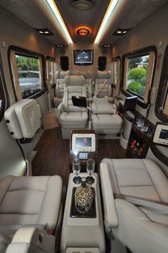 the inside of a bus with leather seats and electronic gadgets on each seat area