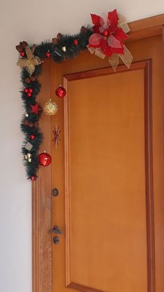 a wooden door decorated with christmas decorations