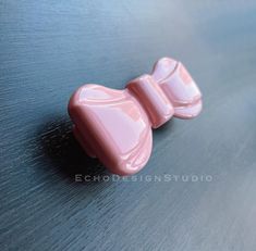 two pink candy like objects sitting on top of a table