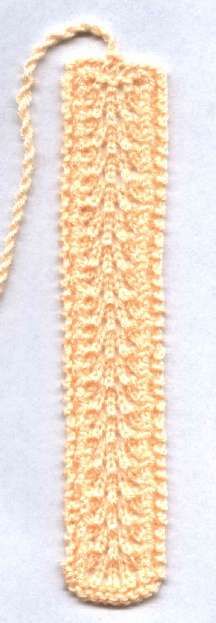 a crocheted bookmark is shown on a white surface with a string attached to it