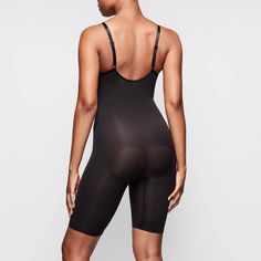 With a mid-thigh length, this essential shapewear bodysuit holds in your core, shapes and lifts your butt and chest, and smooths your upper thighs. Thigh Sculpting, Sculpting Bodysuit, Black Seamless, Shapewear Bodysuit, Waist Trainer, Style Accessories, Skirt Leather, Sweatshirt Shirt, Shapewear