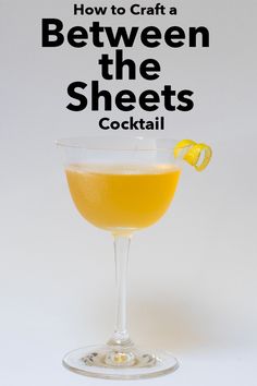 a glass filled with liquid and garnished with a lemon slice on the rim