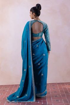 Firozi blue handwoven saree with floral embroidered border. Paired with a handwoven blouse and petticoat. - Aza Fashions Blue Embroidered Pre-draped Saree For Transitional Season, Fitted Pre-draped Saree In Dola Silk With Zari Weaving, Fitted Pre-draped Saree With Zari Weaving For Reception, Pre-draped Saree With Embroidered Border For Diwali Ceremonies, Fitted Tussar Silk Pre-draped Saree With Zari Weaving, Blue Cotton Silk Traditional Wear For Reception, Festive Fitted Pre-draped Saree With Zari Weaving, Embroidered Cotton Silk Choli With Traditional Drape, Art Silk Blouse With Embroidered Border For Wedding