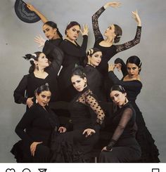 a group of women dressed in black posing for a photo