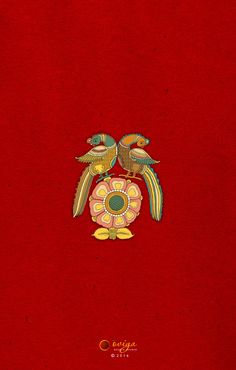 two birds sitting on top of a red book with gold trimming and an ornate design