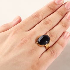 An impressive design with a chic vintage art-deco pattern! Crafted from 10k yellow gold, this stunning ring features one oval black onyx cabochon. Hats off to you and your impeccable taste! Metal: 10k yellow gold Stone: natural black onyx Stone size: 1.5 x 2.0 cm (0.6" x 0.8") Shape: oval cabochon Setting type: bezel Black Cabochon Signet Ring For Formal Occasions, Formal Black Cabochon Signet Ring, Formal Black Oval Cabochon Signet Ring, Classic Black Oval Cabochon Ring, Classic Black Cabochon Rings, Vintage Black Oval Cabochon Ring, Elegant Black Oval Signet Ring, Formal Black Cabochon Rings, Formal Black Oval Signet Ring