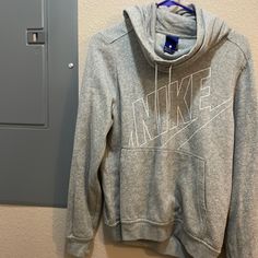 Brand:Nike Color: Gray, White Lettering Size: Medium Condition: Good Explanation: Currently Moving And Selling Unused Clothes. I’ve Probably Only Worn This Once And It’s Been In My Closet Ever Since. Tons Of Wear Left In It And Super Cozy. Open To Offers! Feel Free To Ask Questions. Will Ship Asap! Nike Cotton Tops For Winter, Nike Casual Top With Drawstring Hood, Nike Fall Hoodie Top, Nike Casual Hooded Top, Nike Fall Hoodie, Nike Casual Hoodie Tops, Nike Hooded Tops For Spring, Nike Hoodie Tops For Athleisure, Nike Athleisure Hoodie Tops