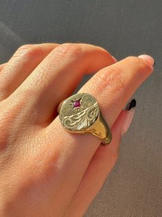 Vintage 9k yellow gold ring from Birmingham, England. This Victorian revival signet ring features a starburst set ruby and classic Victorian filigree on an oval signet. This beautiful piece is quite weighty! Great vintage condition Size: 13.75 resizable* Weight: 8.6 grams Band: 16.0 mm (front), 3.0 mm (back) Ruby: 2.8 mm round cut Hallmarks: 375 for 9k, scale for gold, anchor for Birmingham, 'CJ' for makers mark Victorian Filigree, Victorian Revival, Birmingham England, Yellow Gold Ring, Signet Ring, Yellow Gold Rings, Makers Mark, Birmingham, Size 13