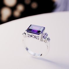 Introducing The Violet Love: This bold statement ring is perfect for any occassion. As a gift for her, a wedding ring or a gift for yourself - because you deserve it - it is guaranteed to impress. This ring is made as a 3-in-1 triple ring set. 2 perfectly fitting bands to complement the big bold center main ring. A bold and beautiful simulated amethyst sits like a crown in the center of a gemstone halo. The sides covered with beautiful simulated diamonds and purple enamel. Underneath you have pr Emerald Cut Ring Set, Triple Ring, Blood Diamond, Emerald Cut Rings, You Deserve It, Luxury Gift Box, Amethyst Gemstone, 3 In 1, Emerald Cut