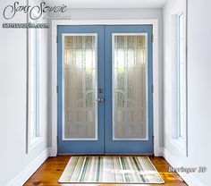 a blue front door with two glass panels and a rug on the floor next to it