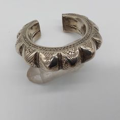 This vintage tribal cuff bracelet from Baluchistan has beautiful wear on it. The piece is hollow, so not terribly heavy Weighing 76.7 g.. The opening is a little over an inch wide and should fit most average size women. A beautiful piece to add to any collection. Bohemian Cuff Bracelet For Ceremonies, Bohemian Engraved Cuff Bracelet, Bohemian Engraved Cuff Bangle, Bohemian Engraved Cuff Bracelet Bangle, Heavy Vintage Bangle For Festivals, Bohemian Engraved Bangle Cuff Bracelet, Bohemian Bangle Cuff Bracelet For Ceremonial Occasions, Traditional Engraved Cuff Bracelet, Bohemian Bangle Cuff Bracelet For Ceremonies