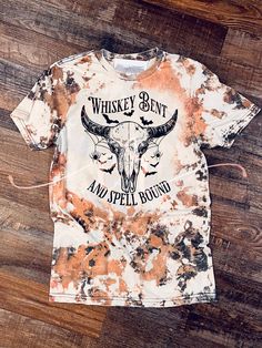 Loving these shirts, this season, all of it!!  Bleached cowhide design with Whiskey Bent and Spell Bound Graphic sublimated on it! LOVE IT! Gildan Heather gray  Bleached and sublimated  Bleach patterns will slightly vary due to hand bleaching !  Have a custom order ? Contact us we'd love to help! Distressed Tie-dye T-shirt For Fall, Distressed Tie Dye T-shirt For Fall, Bleach Tshirt Ideas, Acid Wash Skull Print Top For Halloween, Halloween Acid Wash Skull Print Top, Halloween Bleach Shirt Ideas, Popular Shirt Designs, Bleach Patterns, Shirt Transfers