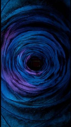 a blue and purple swirl is shown in this image