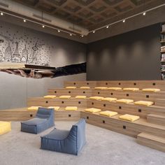 an empty room with several chairs and bookshelves on the wall next to each other