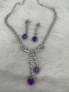 Doublet Purple Pendent CZ Necklace Statement Necklace Silver Finish Perfect Statement Necklace Real Looking Necklace Length : 16 Inches; Earrings Length : 2 Inches; Ready to ship from Boston, Massachusetts. Purple Pendant Jewelry For Party, Silver Teardrop Pendant Necklace With Matching Earrings, Purple Cubic Zirconia Necklaces For Party, Elegant Purple Necklace With Matching Earrings, Silver Necklace Statement, Pakistani Jewelry, Kundan Earrings, Cz Necklace, Boston Massachusetts