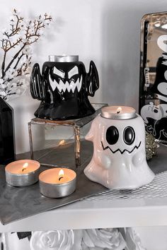 halloween decorations on a table with candles