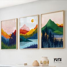 three paintings hang on the wall above a table