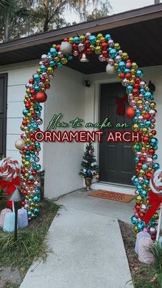 an arch decorated with christmas ornaments in front of a house