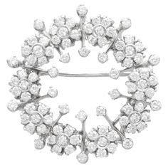 A stunning, fine and impressive vintage Italian 2.78 carat diamond and 18 carat white gold brooch; part of our vintage jewellery collections. This stunning, fine and impressive vintage diamond brooch has been crafted in 18ct white gold. The floriated wreath design is ornamented with ten flower-head cluster tremblant settings; this setting style indicates the high quality of the piece. Each flower head design is embellished with seven transitional modern brilliant round cut diamonds. The brooch i Luxury White Gold Ornate Brooches, Luxury Fine Jewelry Round Brooches, Luxury Vintage Diamond White Jewelry, Luxury Brilliant Cut Diamond White Brooches, Luxury Diamond White Brilliant Cut Brooches, Luxury White Gold Platinum Brooch, Luxury Fine Jewelry Brooches In White Gold, Luxury White Gold Evening Brooches, Luxury White Fine Jewelry Brooches