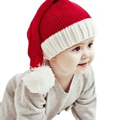 a small child wearing a red and white hat