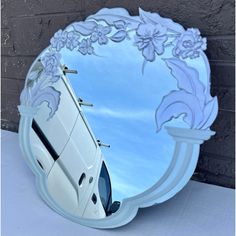 a white van is reflected in a round mirror