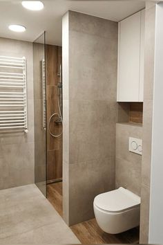 a bathroom with a toilet and shower in it