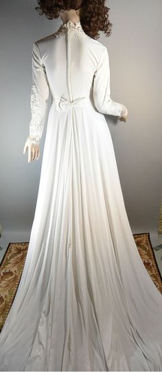 Beautiful 70s Wedding Dress, mermaid style, empire waist, train pins up in back, more of a cream color, excellent condition. Fits like a small but does have some stretch to it. All measurements taken while garment is laying flat. shoulders 16 inches armpit to armpit 16.5 inches (33 around) waist (empire) 13 inches (26 around) nape to hem 58 inches sleeves 24 inches Fitted Floor-length Cream Wedding Dress, Cream Fitted Floor-length Wedding Dress, Fitted Cream Floor-length Wedding Dress, Floor-length Fitted Cream Wedding Dress, Vintage Wedding Dress With Fitted Bodice And Empire Waist, Vintage Floor-length Wedding Dress, Cream Fitted Gown For Bride, Fitted Cream Gown For Bride, Cream Fitted Bridal Gown