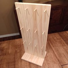 a wooden sculpture sitting on top of a hard wood floor