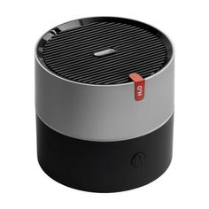 the jbl boom portable bluetooth speaker is black and silver with a red button