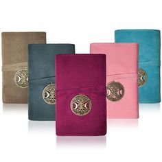 four different colored wallets with gold accents