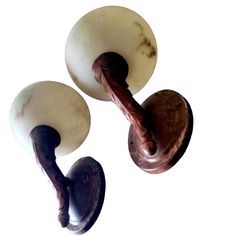 two wooden handles with marble knobs on them