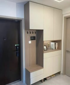 a modern kitchen with white cabinets and wood accents