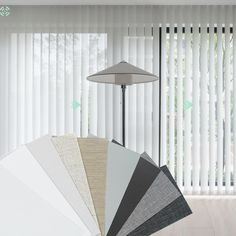 the blinds in this room are all different colors and patterns, but one is white