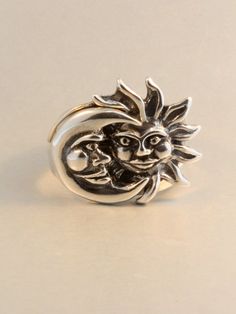 The solid sterling silver Eclipse ring is a striking two part ring set. The Moon half of the ring nestles securely into the rays of the Sun. We have many ring sizes immediately available. We will contact you to let you know if we have your chosen ring size in stock or when to expect shipment. All Marty Magic Jewelry is packaged in a beautiful ring box embossed with the gold foil Marty Magic dragon logo. Perfect for any occasion!Designed in Santa Cruz, California by Marty Magic. Made in the U.S.A Silver Moon Shaped Celestial Ring, Silver Moon-shaped Celestial Ring, Celestial Sun And Moon Design Rings For Anniversary, Celestial Rings With Sun And Moon Design For Anniversary, Mystical Sterling Silver Open Ring, Celestial Moon-shaped Sterling Silver Rings, Celestial Moon Shaped Sterling Silver Rings, Sterling Silver Moon Shaped Celestial Rings, Sterling Silver Crescent Celestial Ring