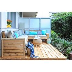 a couch sitting on top of a wooden deck