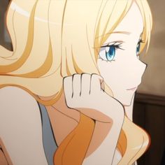 a woman with blonde hair and blue eyes is looking at something in the distance while she's holding her hand to her face