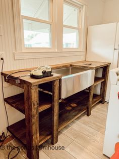 a kitchen area with a sink and refrigerator