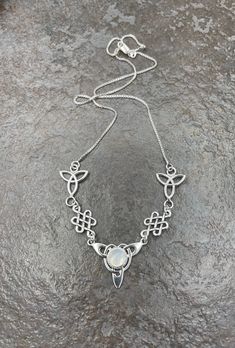 "I've fabricated a Celtic Irish inspired necklace with a center Celtic knot which features a center 8mm round cabochon, of your choosing in the drop down menu, with a total of three component pieces on either side. The sterling chain of 16 inches is soldered to each end making the approximate length of this piece just a bit over 18\" total. The chain will have a sturdy lobster claw. I've fabricated everything in sterling silver - it's a heirloom piece! This is a beautiful and feminine statement Irish Necklace, Irish Wedding, Inspired Necklace, Gifts For My Wife, Moonstone Necklace, Girly Jewelry, Moon Pendant, Choker Necklaces, Celtic Knot