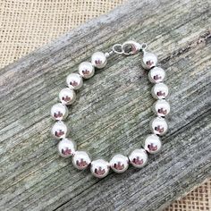 "Beautiful! Classy but simple everyday wear. All shiny round ball 10mm sterling silver bead bracelet. 10mm (LARGE) smooth shiny ball sterling silver beads. 🚩 IMPORTANT IMPORTANT 🚩 10mm are LARGE beads which affects the INSIDE circumference and takes up more room than smaller beads. Please allow a extra room when choosing length. MEASURE WRIST: wrap string around wrist (not tight) and measure end to end. Add about 3/4\" - 1\", depending on your \"comfort\" fit length - loose fit or snug fit. Le Large Beads, Sterling Silver Bead Bracelet, Wrist Wrap, Sterling Bracelets, Silver Bead Bracelet, Ball Bracelet, Silver Bead, Extra Room, Sterling Silver Bead