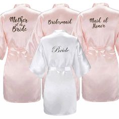 three robes with the names of bride and groom on them, one in pink and one in white