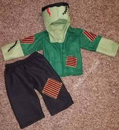 a child's green jacket and black pants with red stripes on the sleeves, both worn by a toddler